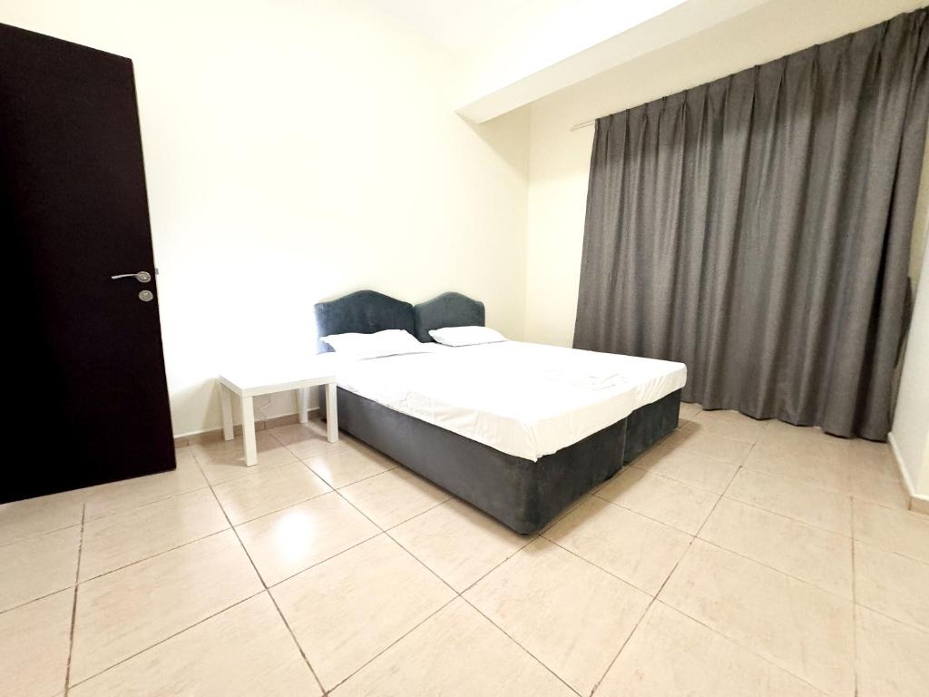 a bedroom with a large bed in a room at Nahda Star Residence - Home Stay in Dubai