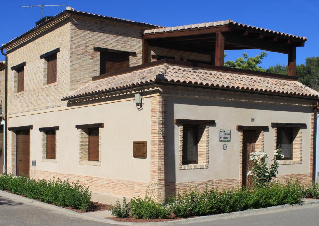a brick building with windows on a street at Casa Rural Maria Isabel in Puigmoreno
