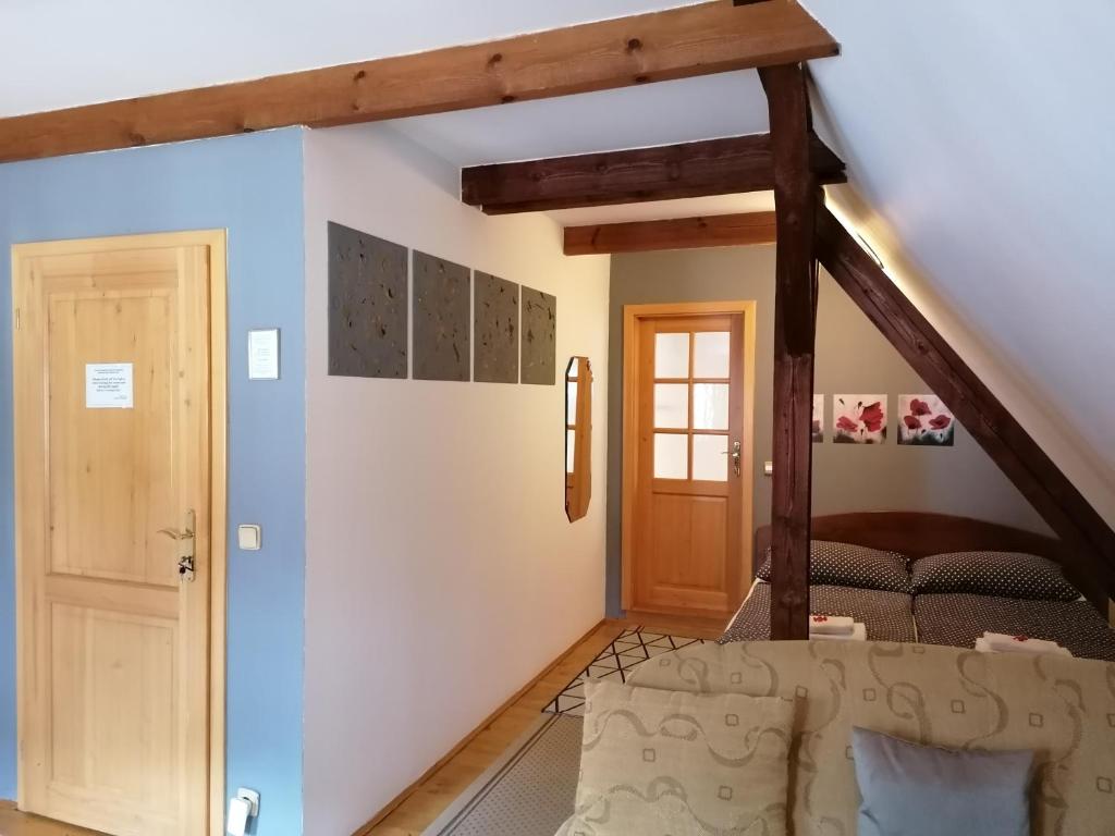 a room with a bed and a wooden door at Guest House Olšakovský in Český Krumlov