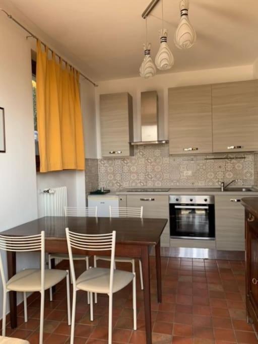 a kitchen with a dining room table and chairs at [Appartamento Girasole] in Varzi