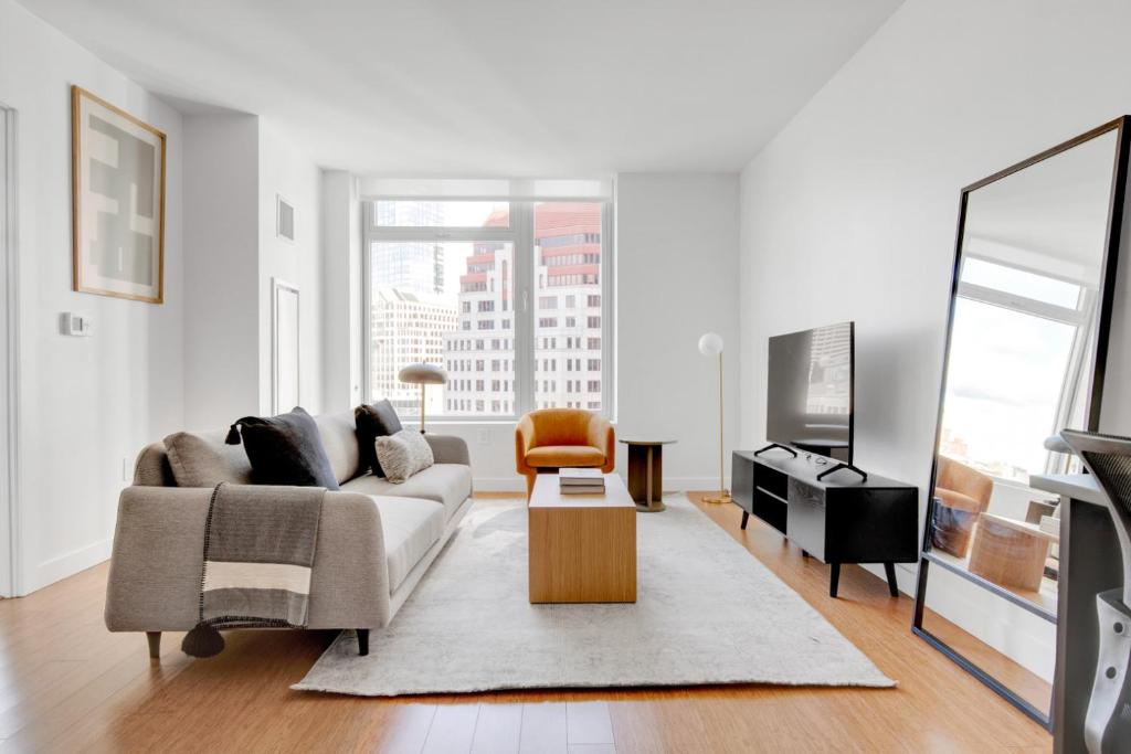 a living room with a couch and a tv at Downtown 1BR w Gym WD nr S Station BOS-619 in Boston