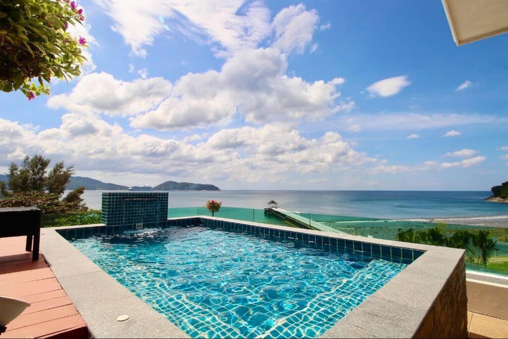 a swimming pool with a view of the ocean at Luxury Rooftop Penthouse in Ban Nakhale