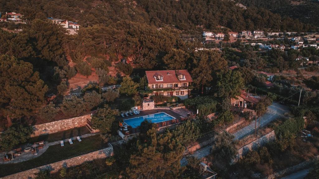 an aerial view of a house with a swimming pool at Faralia Hotel in Faralya