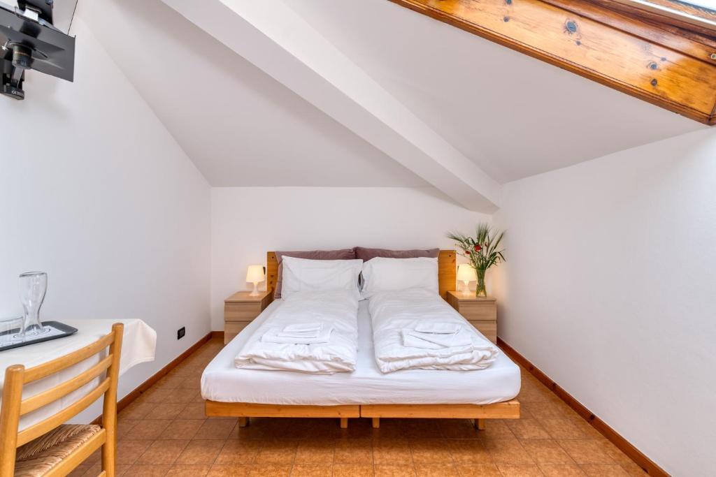 Postel nebo postele na pokoji v ubytování Hotel Martinelli