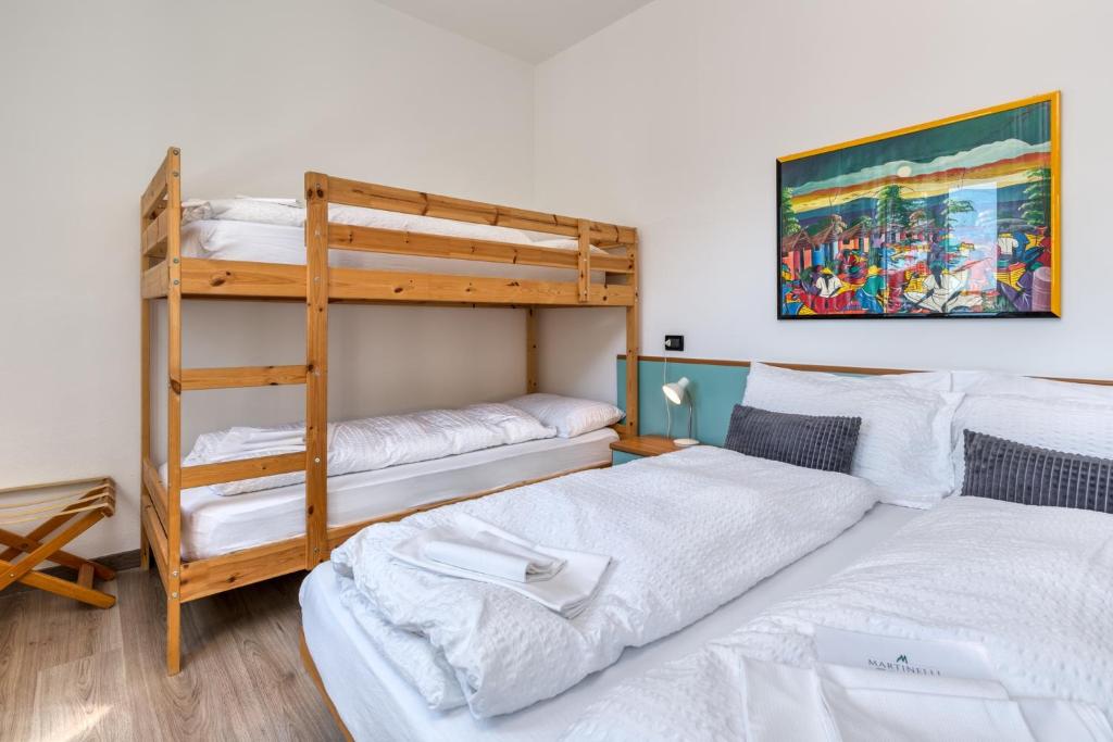 Postel nebo postele na pokoji v ubytování Hotel Martinelli