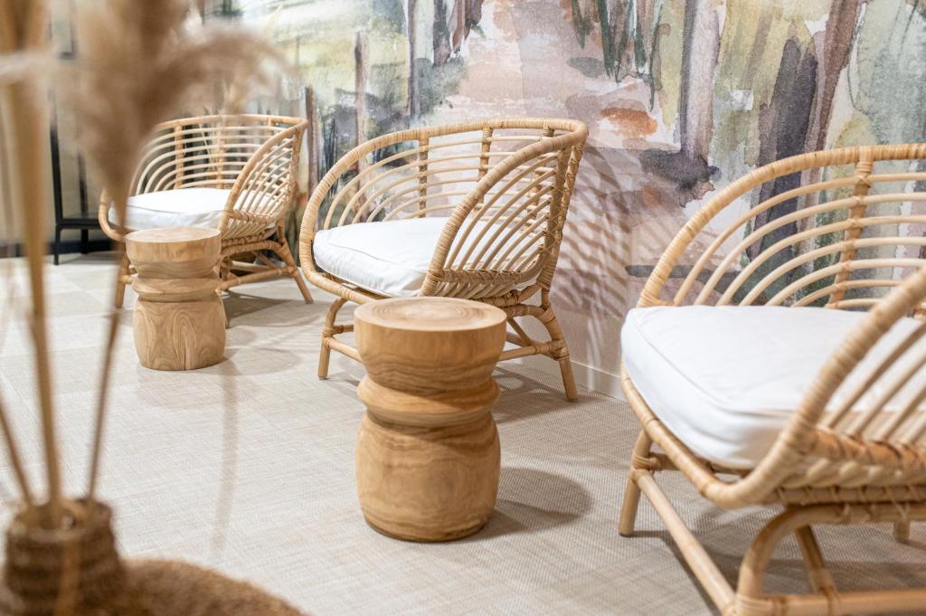 a group of chairs sitting on a patio at Kyriad Prestige Residence & Spa Cabourg-Dives-sur-Mer in Dives-sur-Mer