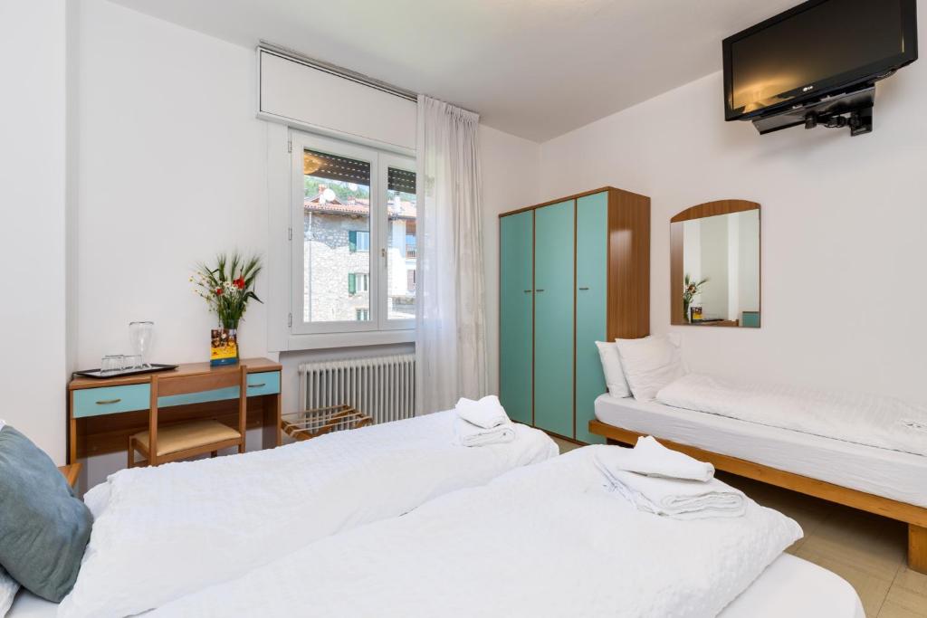 Postel nebo postele na pokoji v ubytování Hotel Martinelli