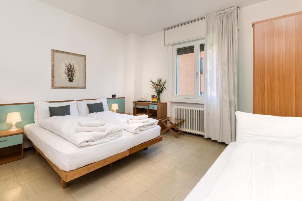 Postel nebo postele na pokoji v ubytování Hotel Martinelli