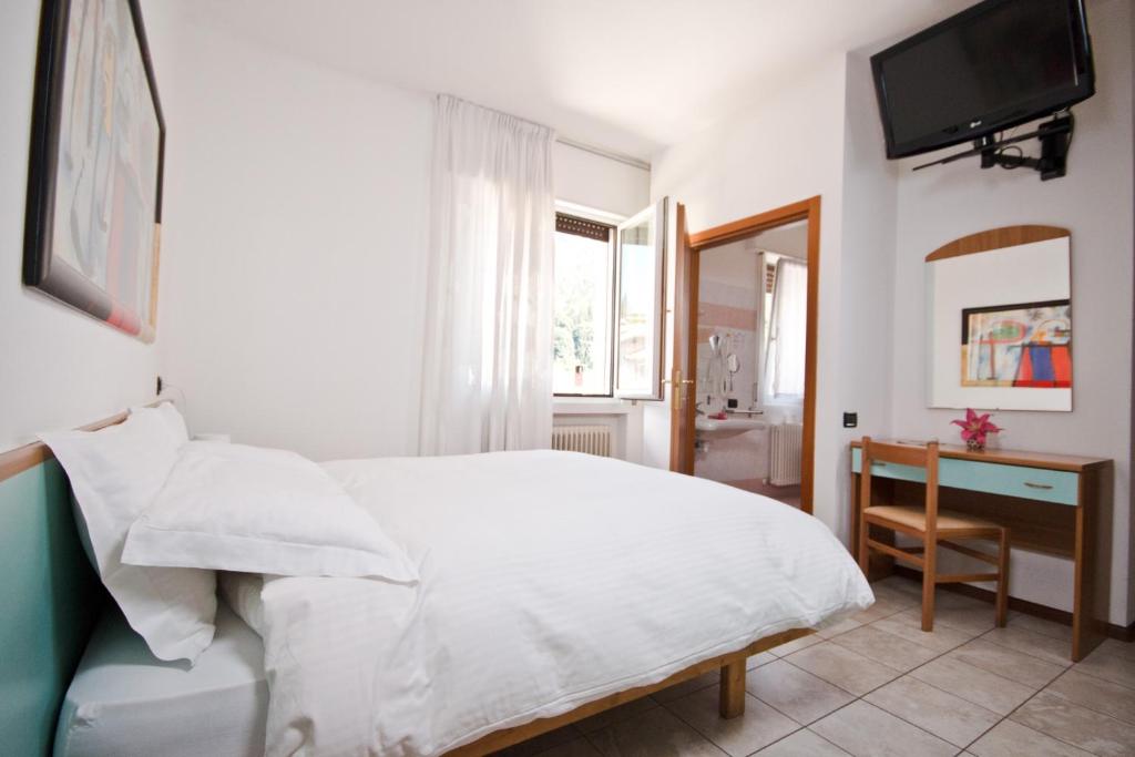 Postel nebo postele na pokoji v ubytování Hotel Martinelli