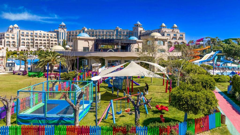an amusement park in front of a large building at Spice Hotel & Spa - Ultra All Inclusive in Belek