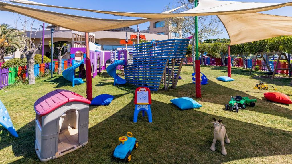 a playground with a tent and play equipment on the grass at Spice Hotel & Spa - Ultra All Inclusive in Belek