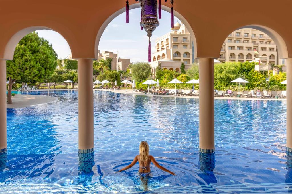 a woman swimming in a pool at a resort at Spice Hotel & Spa - Ultra All Inclusive in Belek