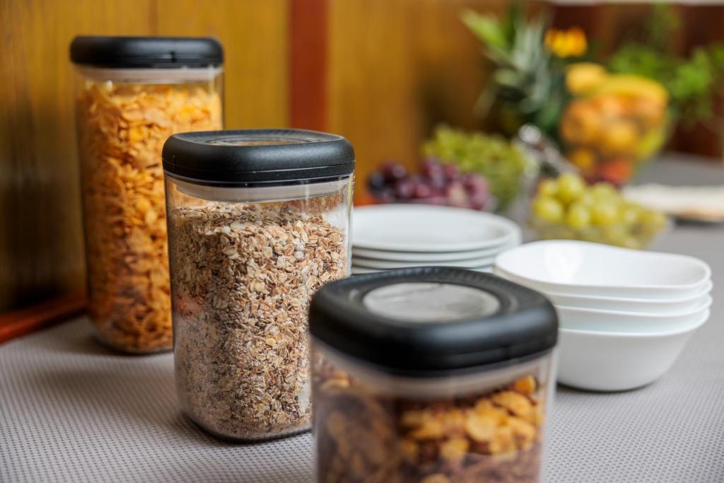 three jars of nuts and seeds on a table at Pansion Maltar Varaždin in Varaždin