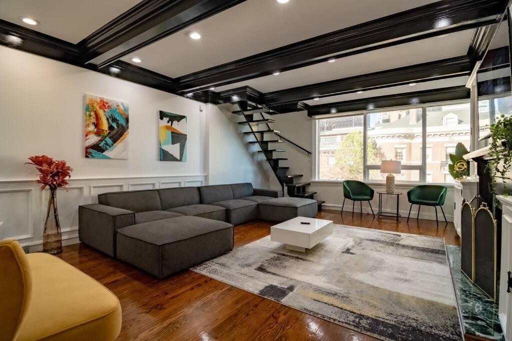 a living room with a couch and a staircase at 4Bedroom Gold Coast Duplex with Jacuzzi in the Bedroom and Optional Valet Parking in Chicago