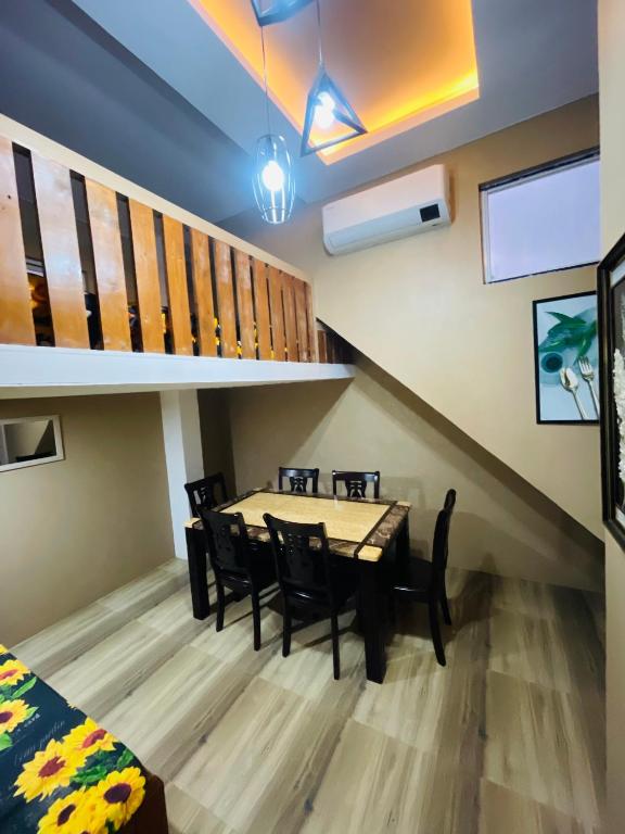 a dining room with a table and chairs at Zenhouse Calayo in Nasugbu