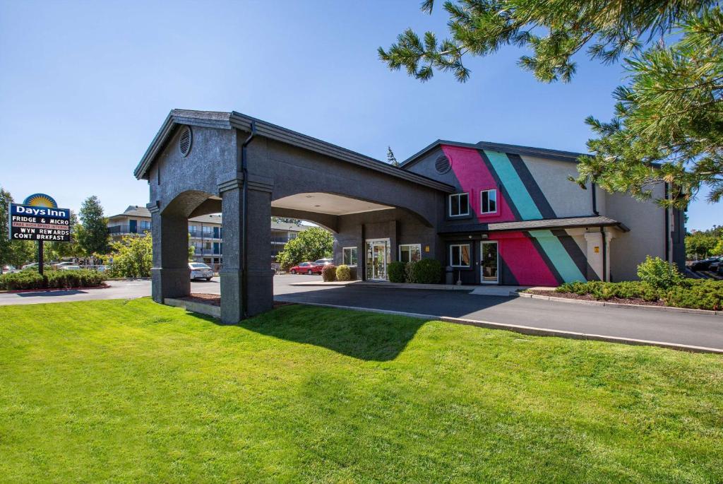 a building with a colorful facade on a street at Days Inn by Wyndham Flagstaff I-40 in Flagstaff