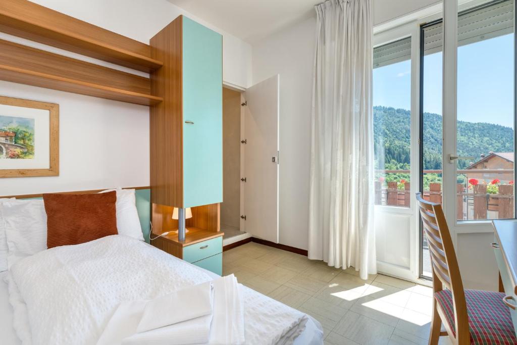 Postel nebo postele na pokoji v ubytování Hotel Martinelli