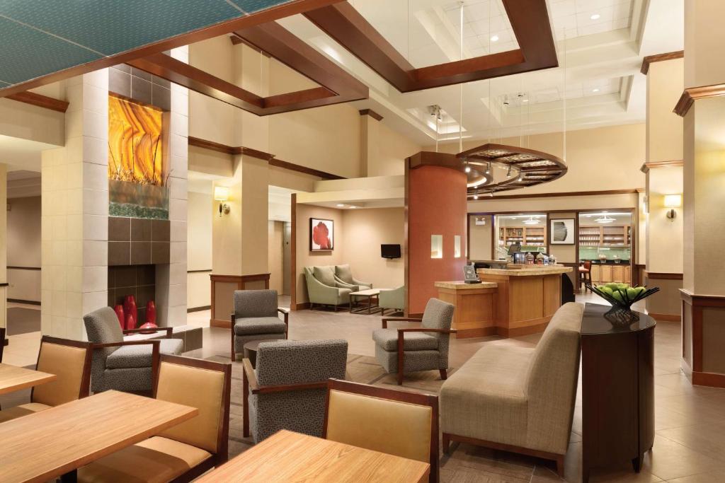 a lobby with chairs and tables and a waiting room at Hyatt Place Fremont/Silicon Valley in Warm Springs District