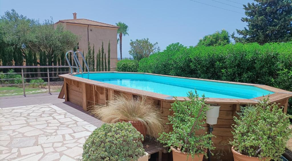 a swimming pool in a garden with potted plants at Villa Can Bolloy Mallorca in Llucmajor