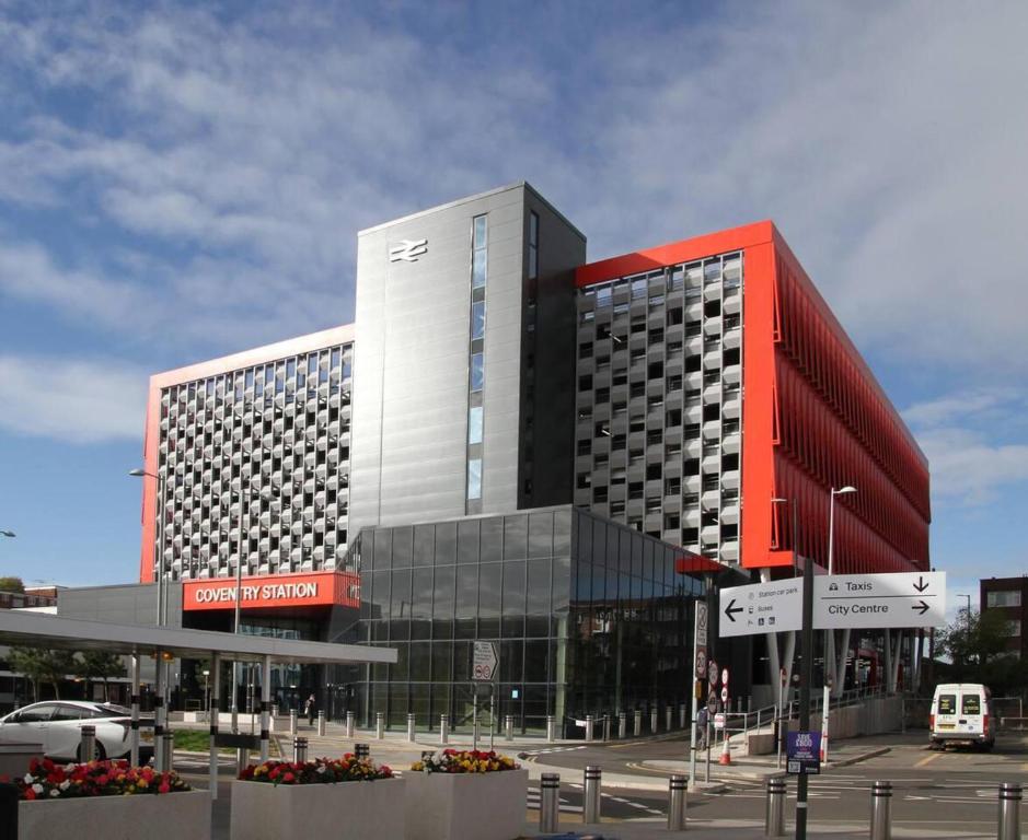 a large building with a red and white at Impeccable 2-Bed House in Coventry in Coventry