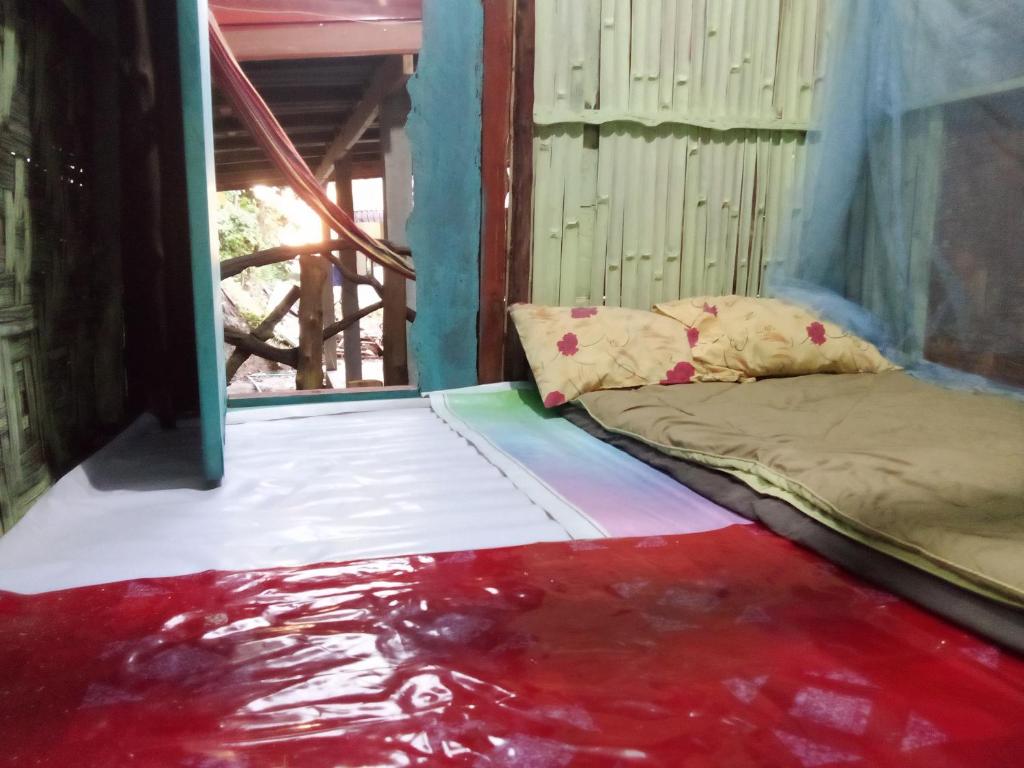 a bed in a room with water on the floor at The Rock Hut in Ko Lanta