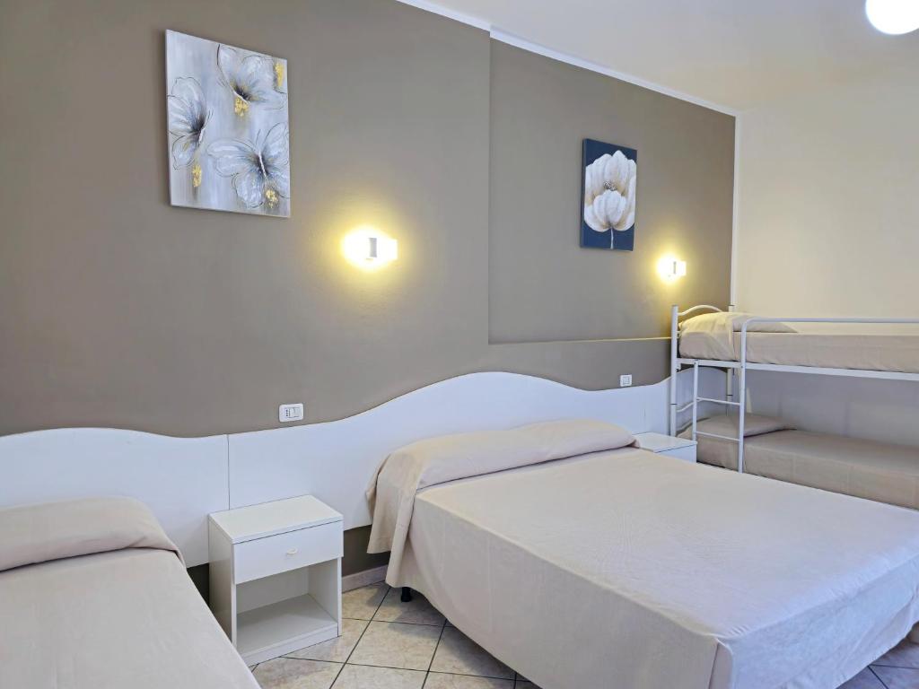 Postel nebo postele na pokoji v ubytování Hotel Baia del Cigno