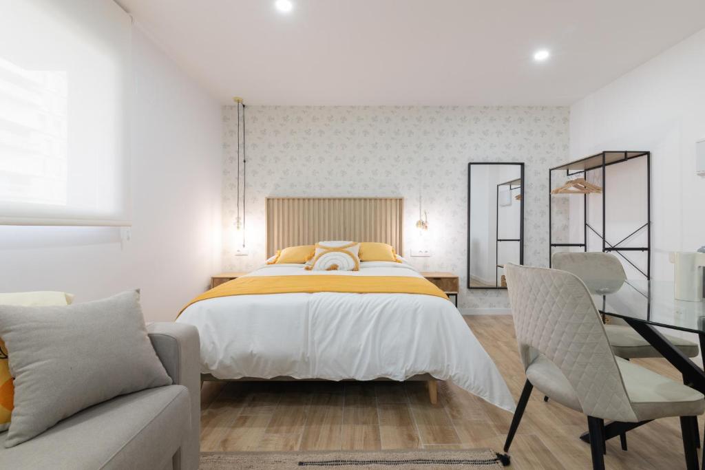 a bedroom with a large bed and a couch at DormForYou Arena Standard in Valencia