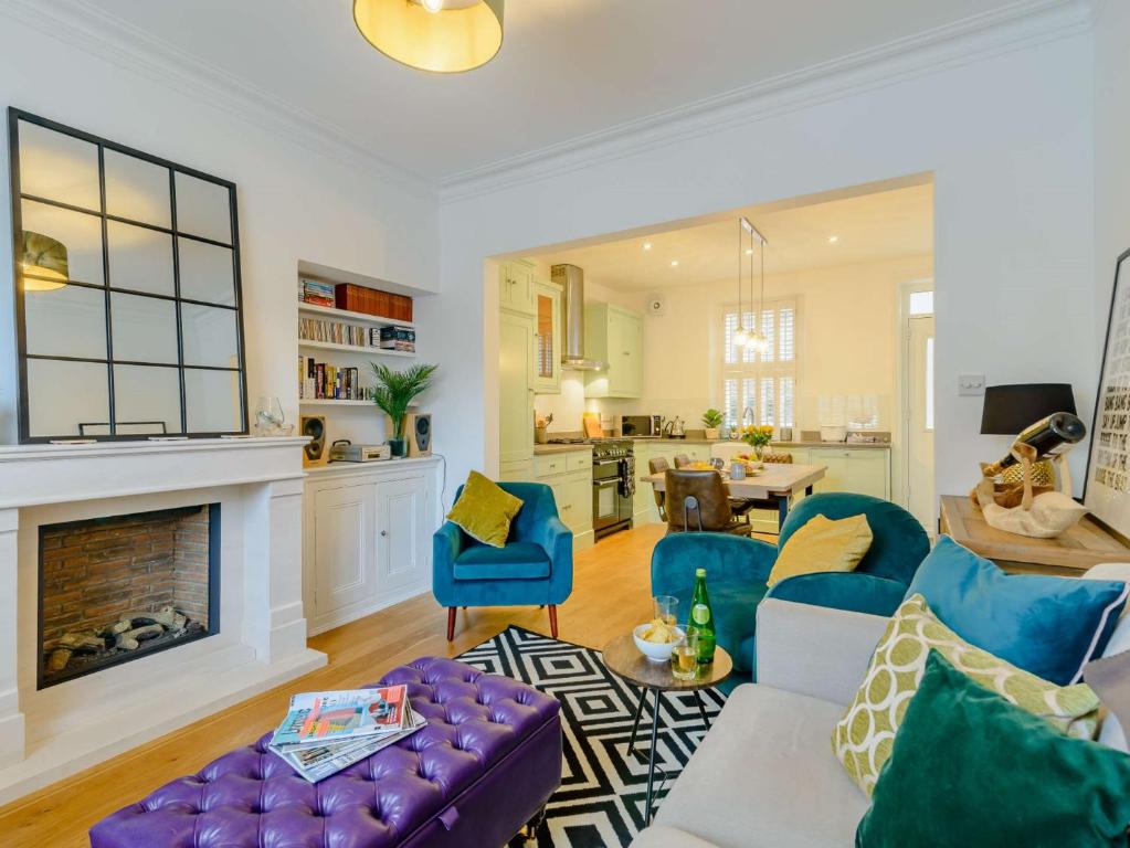 a living room with blue chairs and a fireplace at 3 Bed in Harrogate 90032 in Harrogate