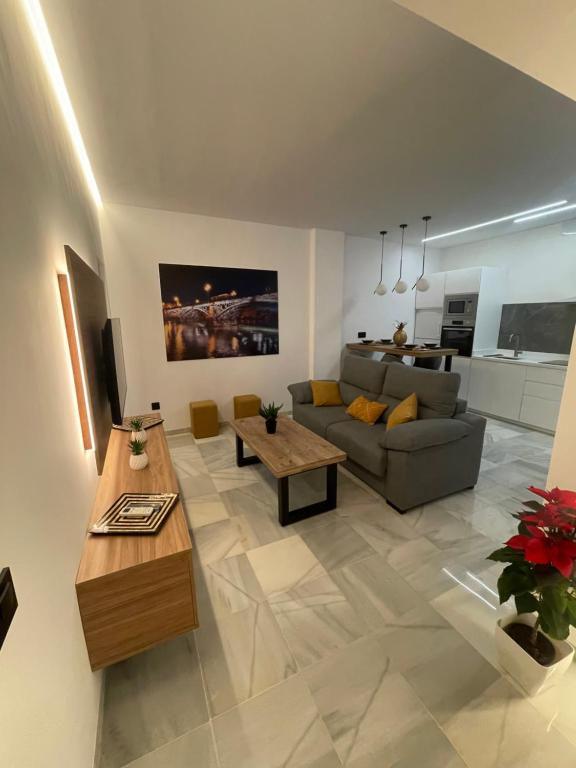 a living room with a couch and a table at WISH SUITE PONCE DE LEON in Seville