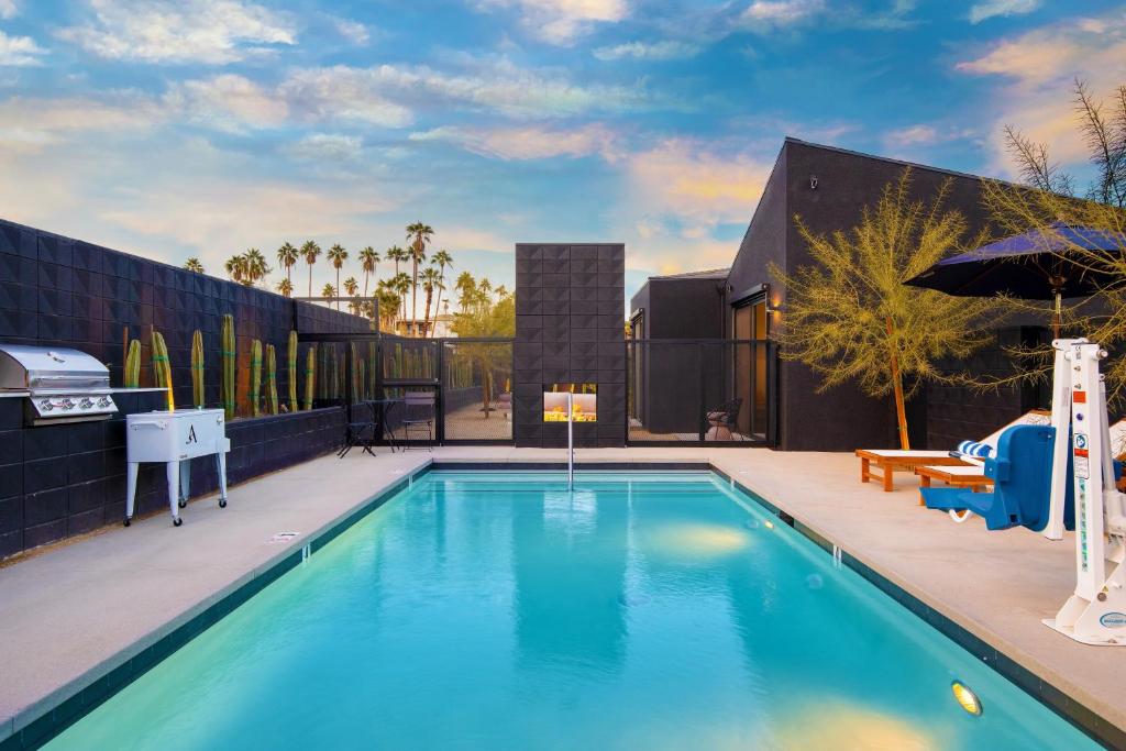 a swimming pool in the backyard of a house at Blackhaus A B Buyout by AvantStay Sleeps 16 in Palm Springs