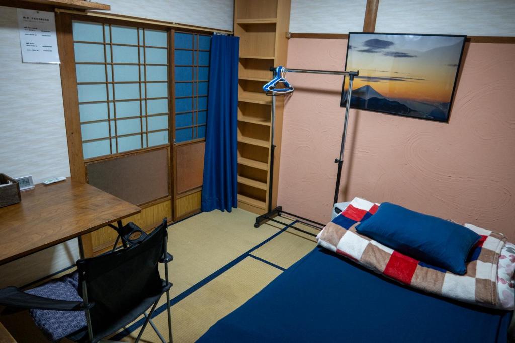 Postel nebo postele na pokoji v ubytování Guest House Tokiwa