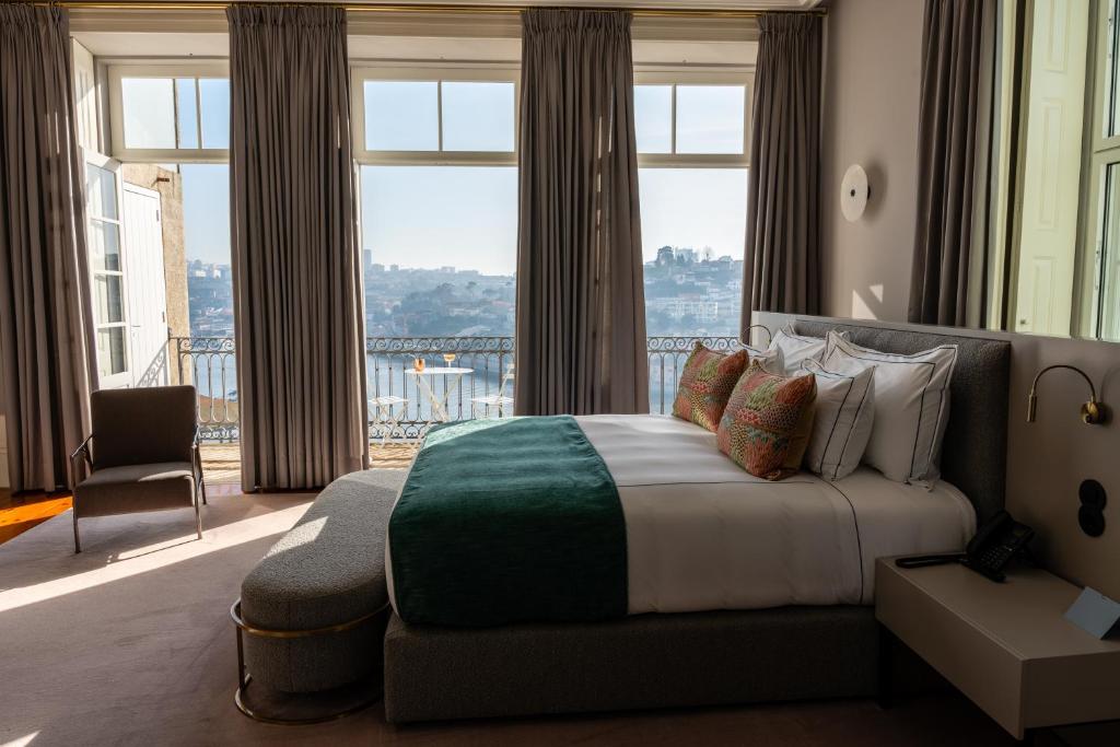 a bedroom with a large bed and a large window at Maison Bleue in Porto