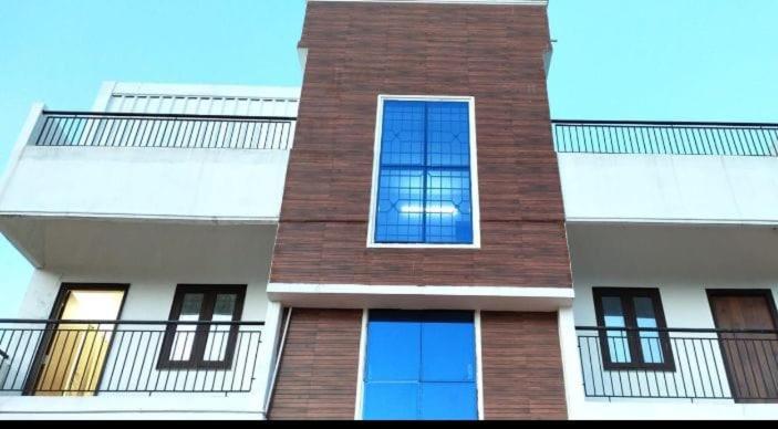 a tall brick building with windows and a balcony at AVM Paradise in Yelagiri