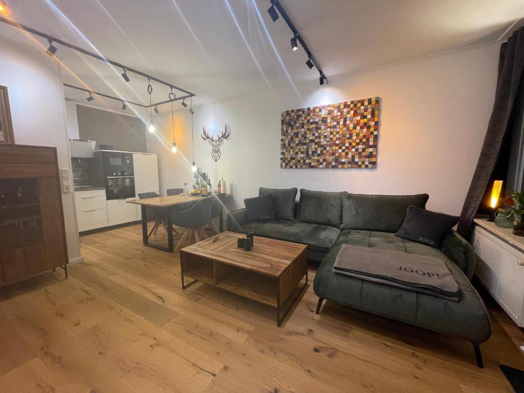 a living room with a couch and a table at Apartment Beletage Bad Harzburg in Bad Harzburg