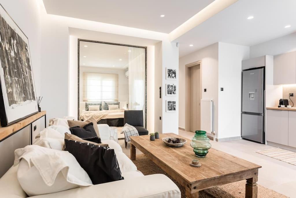 a living room with white furniture and a table at Downtown Urban Luxurious Apartment in Athens