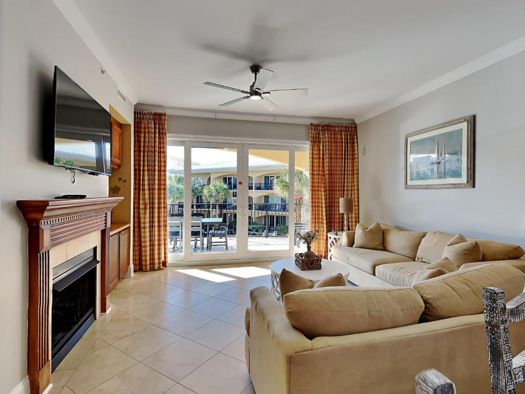 a living room with a couch and a television at Adagio 203E in Santa Rosa Beach