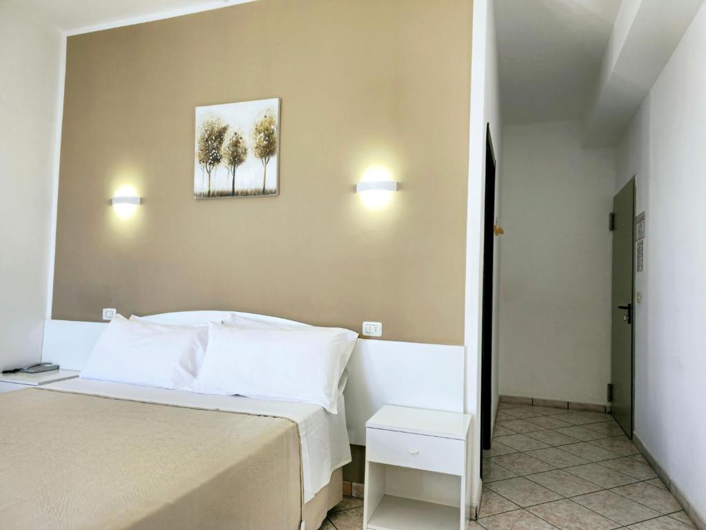 Postel nebo postele na pokoji v ubytování Hotel Baia del Cigno
