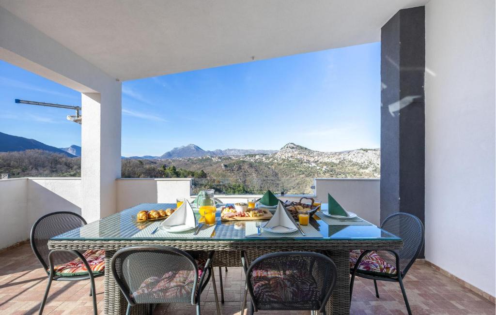 a table with a plate of food on a balcony at Amazing Apartment In Slime With Wifi in Slime