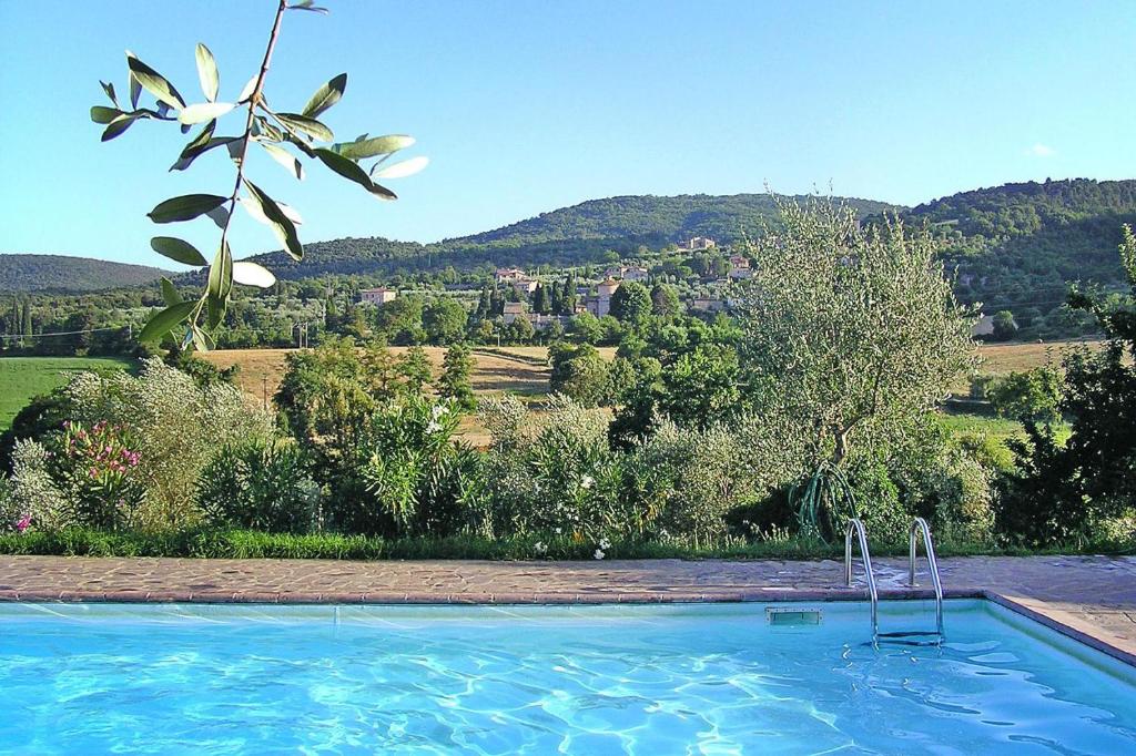 a swimming pool with a view of a mountain at Apartment in Sovicille with heating in Sovicille