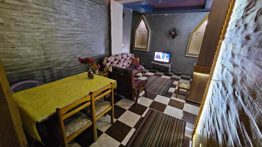 a living room with a table and a couch at Shared Room near Pyramids! in Cairo