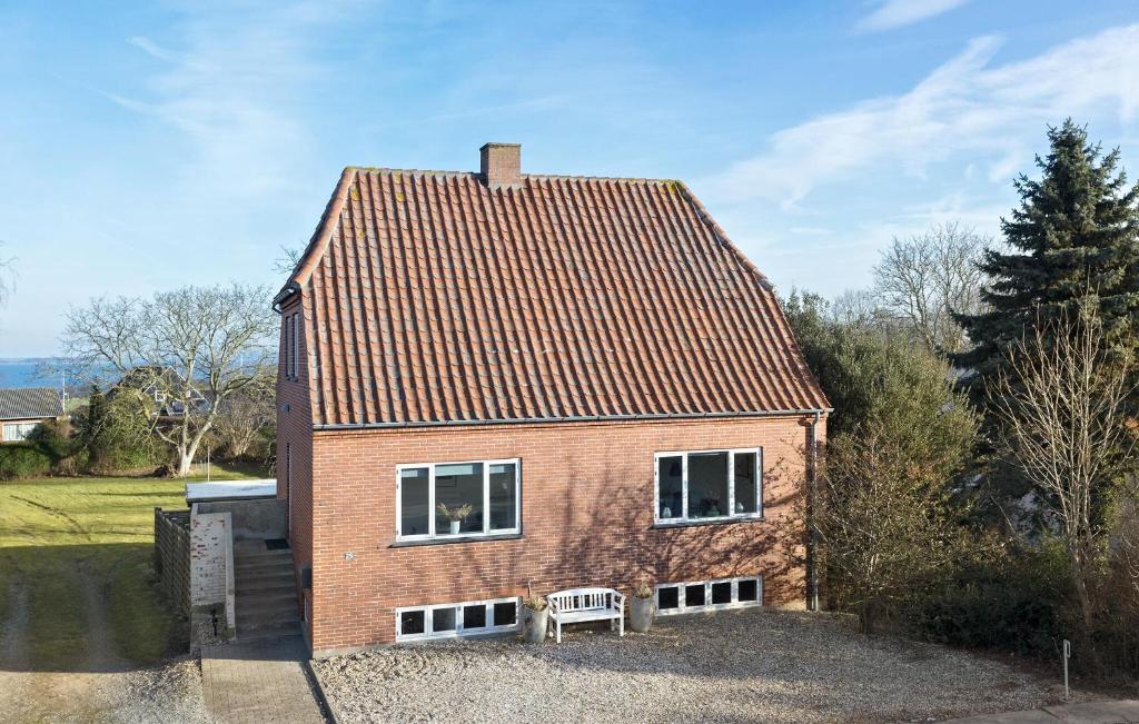 a small red brick house with two windows at Gorgeous Home In Sby r With Wifi in Søby