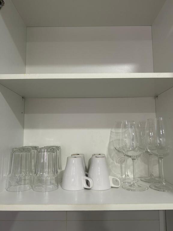 a shelf with wine glasses and cups on it at Portalegre in Madrid