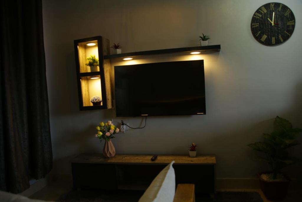 a flat screen tv on the wall of a living room at Enn lovely apartment 10 in Bungoma