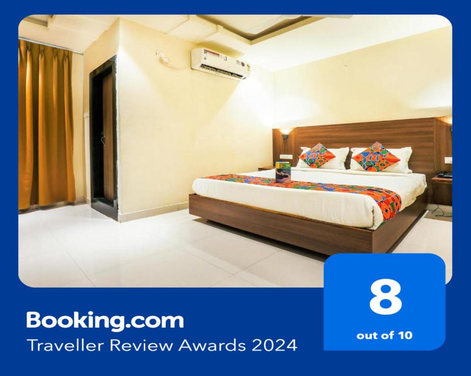 a bedroom with a bed in a hotel room at FabHotel RR Grand MG Road in Vijayawāda