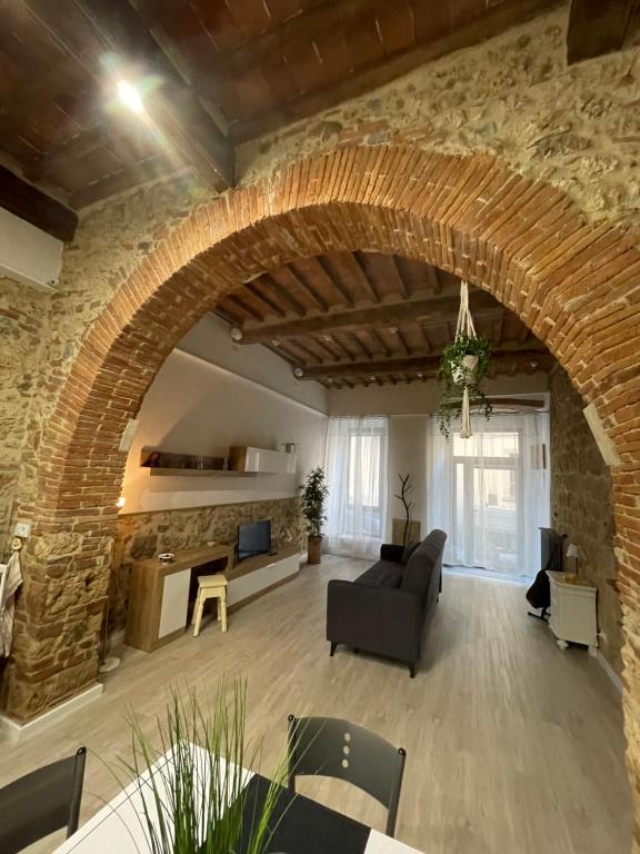 a large living room with a brick wall at La Casina del Corso in Massa Marittima