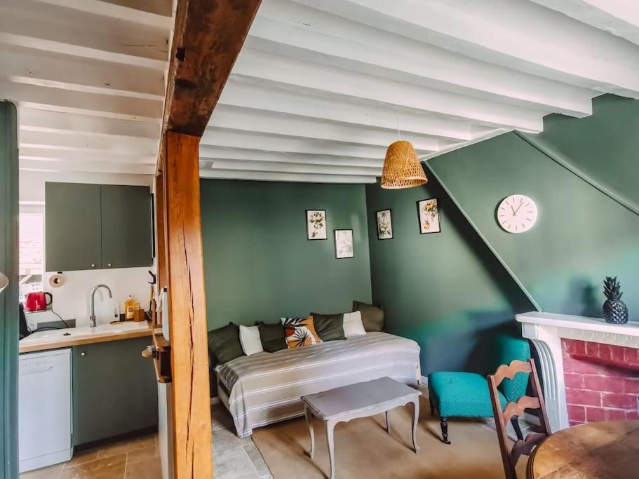 a bedroom with a bed and a sink in a room at Le val en chêne in Choisy-au-Bac