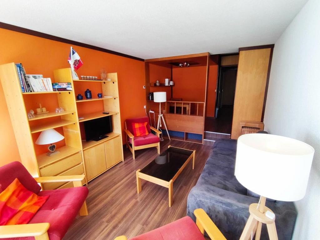 a living room with orange walls and red furniture at Appartement Isola 2000, 4 pièces, 8 personnes - FR-1-292-186 in Isola