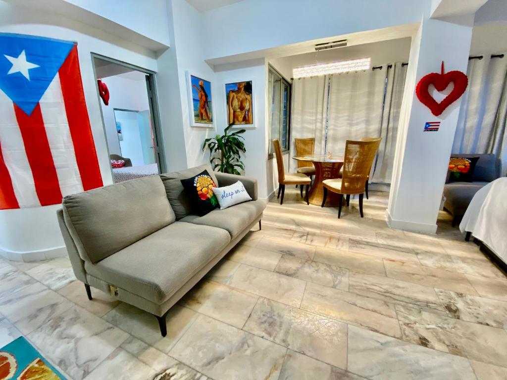 a living room with a couch and an american flag at Condado Paradise Tantra Apartment in San Juan