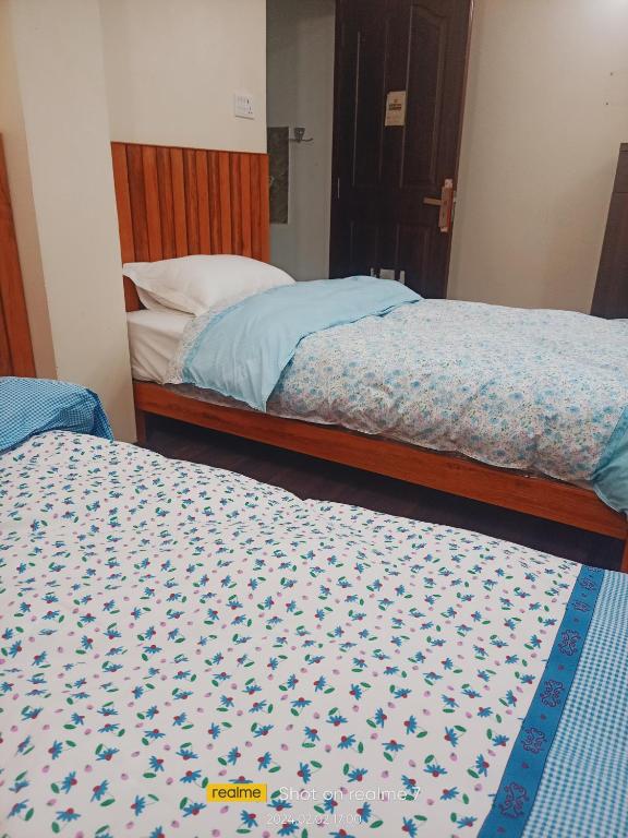Postel nebo postele na pokoji v ubytování Nirvana Kuti