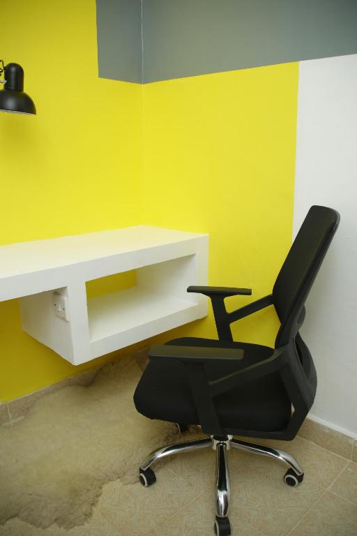 a black office chair sitting next to a white desk at Enn lovely apartment 12 in Bungoma